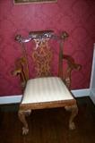 One of the two armed chairs in the set of dining room chairs