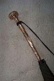 Victorian era umbrella with a gold plated/mother of pearl long handle.  