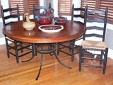 •	Breakfast Table, Round Red Mahogany Top Over Four Flared Wrought Iron Legs w/ Patterned Center Ring, 54"D, Kinkaid Furniture, 
Four Black Ladder Back Chairs w/ Rush Seats, Michael Smith Pottery
