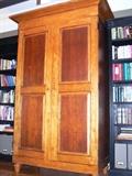 •	Media or Clothing Armoire, Mixed Wood w/ Distressed Finish, Beveled Panel Doors, Interior w/ Two Cubbies Over Two Drawers, Wide Flared Crown, Turned Tapered Feet, 56"W X 27"D X 88"H