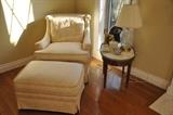 Beautiful cream colored upholstered chair with ottoman and vintage marble side table