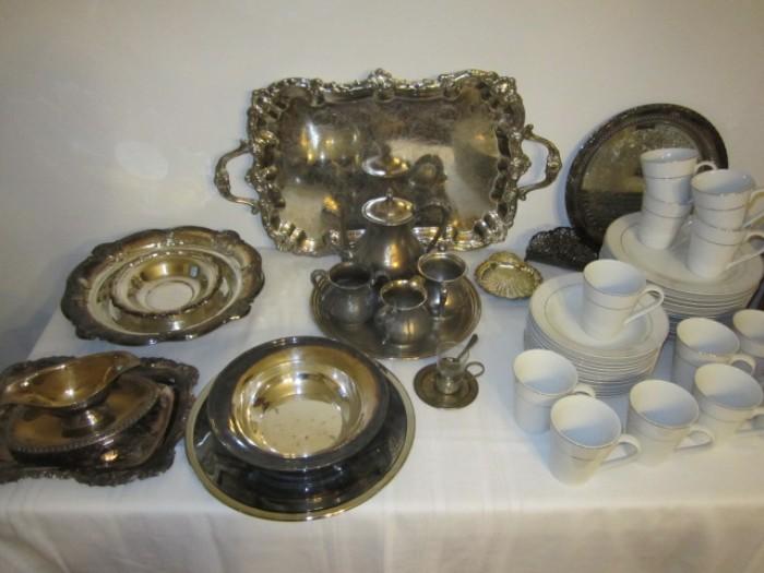 SIlver plate serving pieces and white china with small gold band