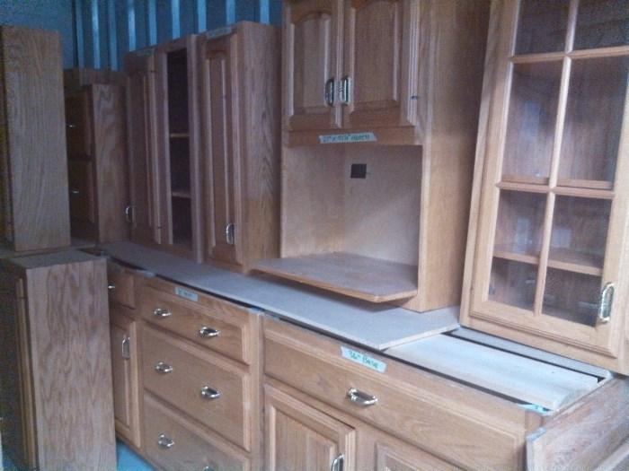 18 ft of bottom and top light oak kitchen cabinets and island. Ready to install