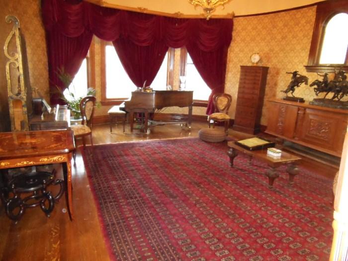 One half of the Living Room with a Large Bokhara Rug; a 1927 Knabe Baby Grand Reproducing Player Piano