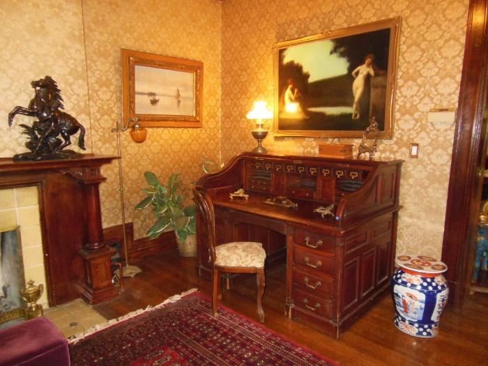 Antique Mahogany Roll-Top Desk; "Nymphs" Original Oil by Listed Artist Jean-Jacques Henner (1829 - 1905);   "Bay at Castle Elsinore" Original Oil by Listed Artist Olaf Krumlinde (1856-1945); and a Chinese Ceramic Stool next to a large Mahogany Roll-Top Desk
