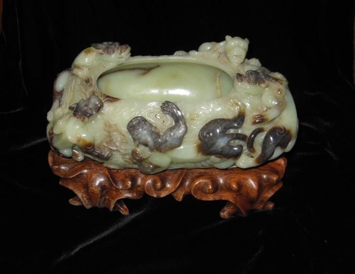 A Finely Carved Antique Celadon & Russet Jade Bowl on a wooden base.  12" long.