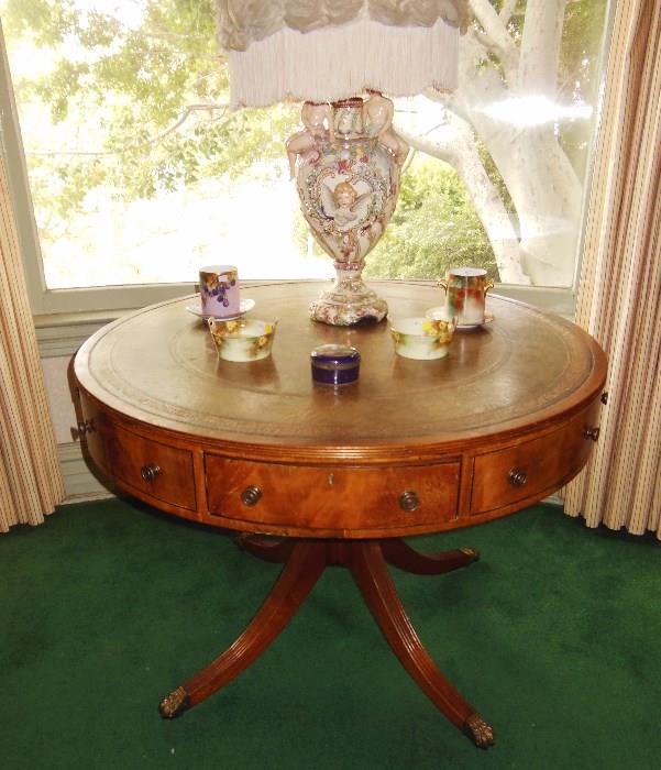 Flame Mahogany Revolving Drum Table w/ Leather Top; and an Antique Capo di Monti Lamp.
