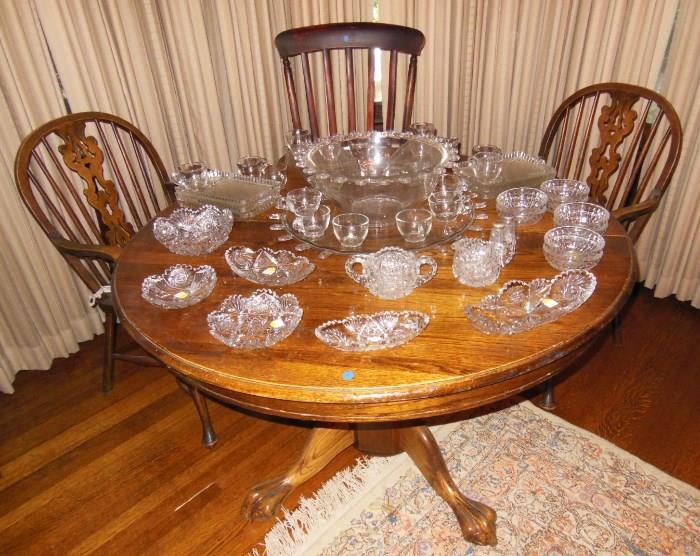 Craftsman-Style Oak Dining Table with an Assortment of Cut Crystal and Vintage Glass; with Antique Windsor Chairs.