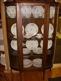 Curved glass oak china cabinet with assembled set of Haviland China inside (same pattern, different 'blanks'.)