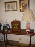 1920's era sofa table with Triple Chime bracket clock (Works), lamp and Egyptian prints above