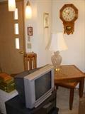 Older TV, Tables made by Jim Watt from large tiles, crystal lamp, Schoolhouse style maple clock (works)