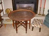 Foreign travel souvenirs including this copper tray table.  Copper top weighs 17 pounds!