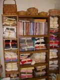 Fabric and material.  Shelf in center is full of books on quilting, sewing, etc.