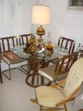 Bamboo base (glass top) table and chairs, along with many decorative items.  Older rocker in foreground