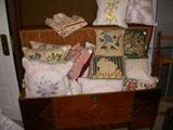 Waterfall style cedar chest full of throw pillows