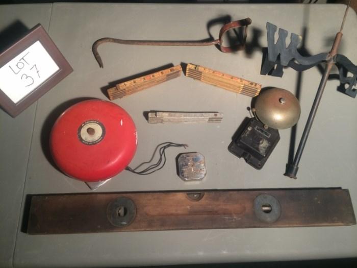 Antique level, rulers, toy bank, hook, bells, and weathervane. What a neat assortment! Items are in fair to good condition.