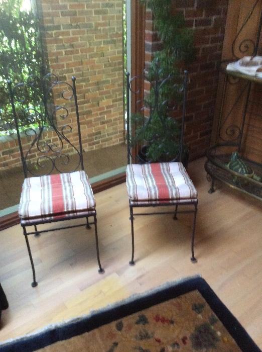 Two of a set of four of iron chairs