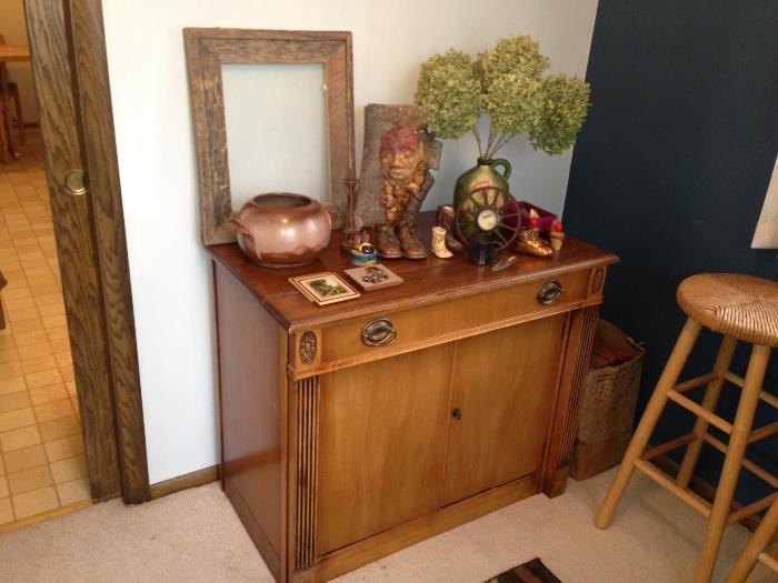Saginaw Furniture Expandable buffet table. Top drawer pulls out to a 7' dining table. Bottom cabinet holds your linens, china, silverware. Includes 4 leaves