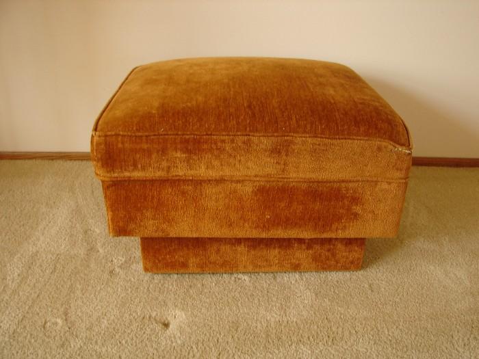 Wheeled ottoman matches upholstered chair.