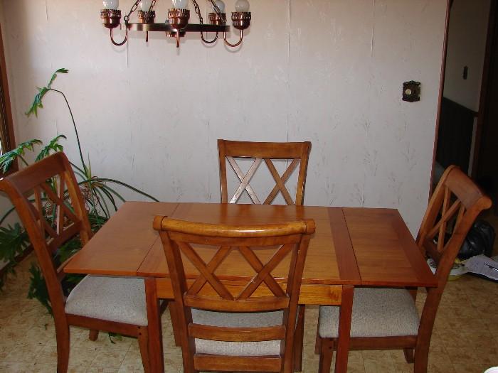 Teak Kitchen table with self-storing end leaves. Pretty color of wood!