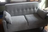 two identical grey loveseats