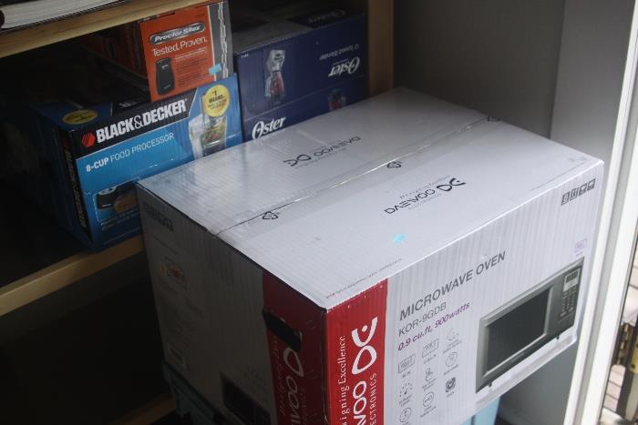 new in the box Daewoo microwave, Black & Decker food processor, Oster mixer