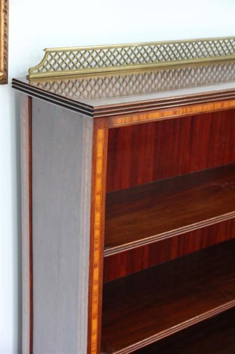 detail of inlay and brass rail on bookcase