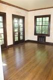 dining room two sets of french doors, oak wood flooring base boards, set of two radiators with grates