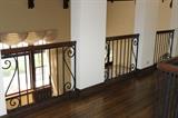 oak and wrought iron banister with oak flooring and floor boards