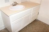 bathroom cabinet with sink and fixtures