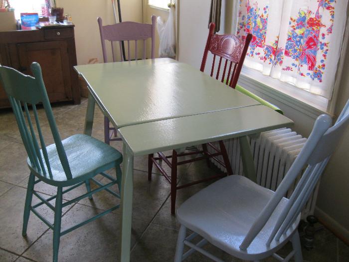 Kitchen table and four pressed backed chairs.