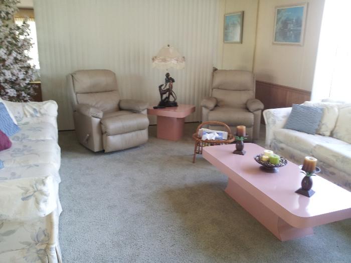 leather tan chair, floral couch and loveseat, cocktail table and matching table