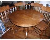 Tiger Oak pedestal table with four chairs, two need to have the seats re-caned