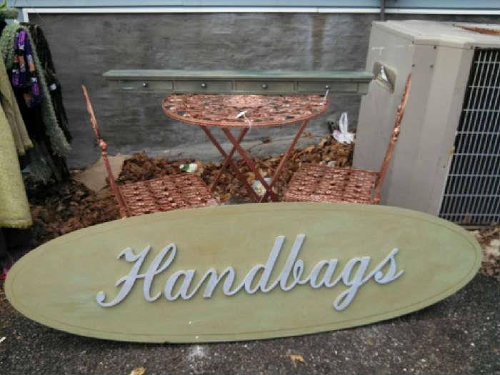 beautiful handbags sign and wrought iron bistro table