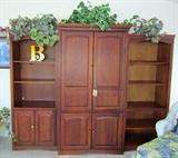 Three piece wall unit, doors move into cabinet.