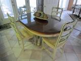This table (with one leaf in place) has a extra glass top for protection.  Set includes four chairs.