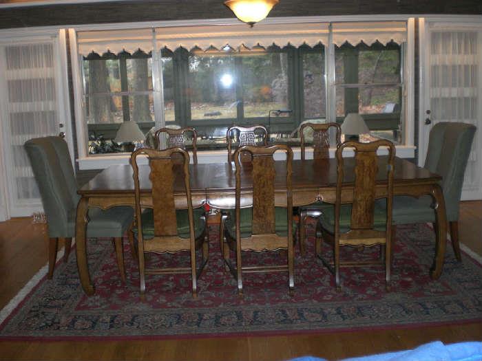 Solid Burl Walnut dining set with two leaves with matching aprons.  Six chairs with suede sears.  Host and Hostess cotton and linen by Mitchell Gold