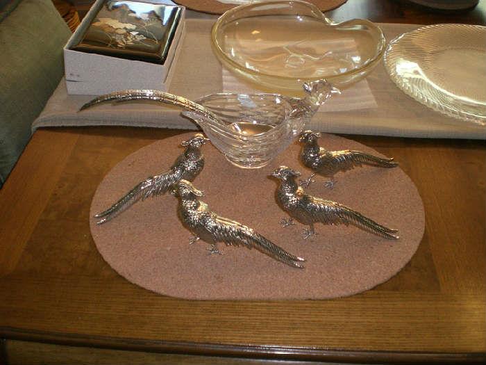 Silver electoplated Pheasant  Salt ,Pepper, serving bowl with Pheasant feather serving spoon and two extra Pheasant show birds. Notice in the foreground the Elsa Peretti Thumb Print glass and gold dish