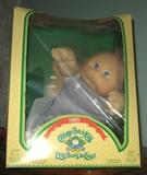 Several Cabbage Patch dolls, one has Notre Dame sweater