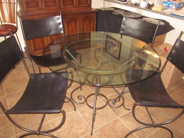 Glass top table with  4 leather / metal  chairs