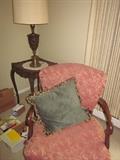 Vintage upholstered chair, antique table and lamp