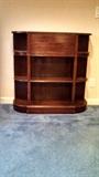 Antique mahogany bow front bookcase with two drawers.