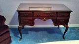 Beautiful antique mahogany desk. Glass covered top.