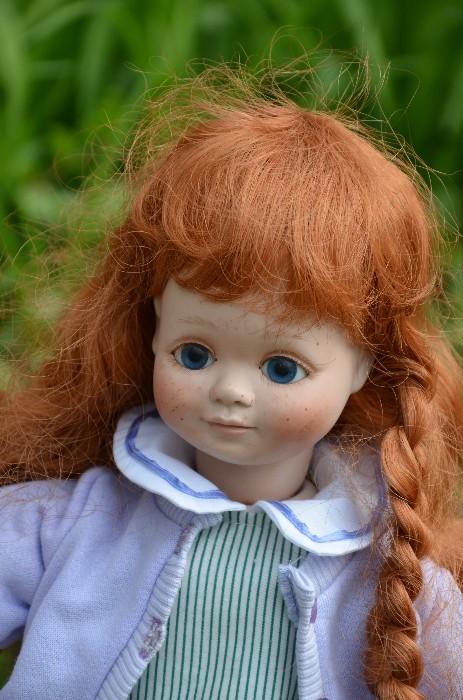 Jamie is an 18" porcelain hand made doll dated 1990. Sweet face with blue eyes, freckles on her cheeks, and long red hair. Only one owner. Kept in exhibit case.