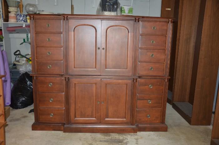 Priced to sell. Elegant solid maple wood chest by Durham Furniture. 14 dove tailed drawers for storage. Victorian Mahogany finish. Rope twist beading across top and rounded pilasters both sides. 6' long x 5' high x 25" deep. Interrior measurements of top cabinet 23" deep x 28" wide by 27" high. A smaller flat sceen would be a perfect finish to this beautiful piece. Sacrifice at $200.