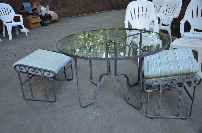 Glass and wrought iron table with two ottomans. Sorry no chairs. Sunday price $45.