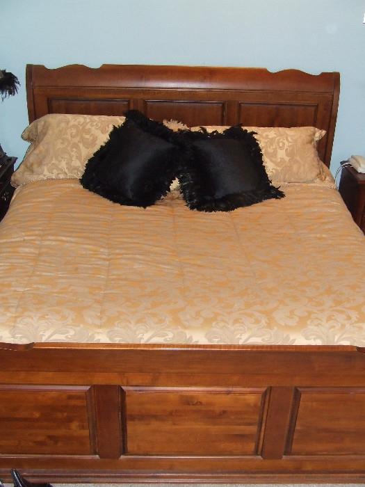 Cherry bedroom set, this king sleigh bed has raised panels and bun feet. Athens of Georgia Furniture Co.