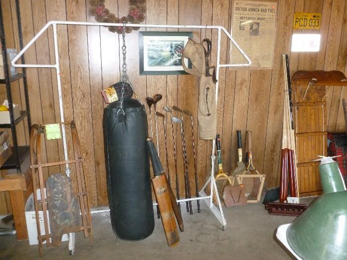 Antique/Vintage sports items..Everlast punching bag & gloves..Cricket Paddles,,,,1920's Bristol  Golf clubs and bag...Bad Mitton & Tennis Rackets...Pool Cues 