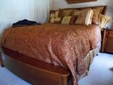 Queen sized.  Duvet, pillows and head/footboard ONLY for sale.  The mattress and boxspring are being kept by owners.