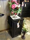 Flower arrangements, small black cabinet